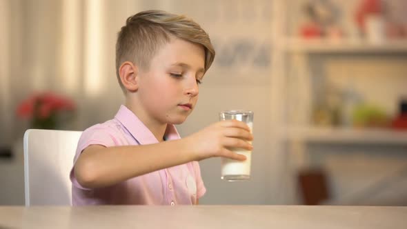 Boy Drinking Fresh Organic Milk From Glass on Table, Morning Energy Food, Dairy