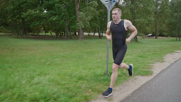 Morning Jog Pro Runner Runs on a Road Athlete Trains in an Nature Environment Preparation for