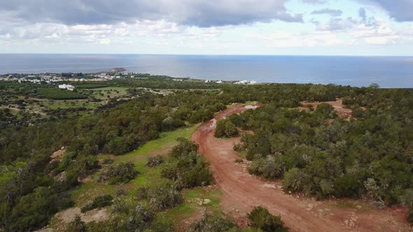 Aerial drone shot of the Akamas Peninsula of Cyprus in Paphos following a dirt path high in the hill