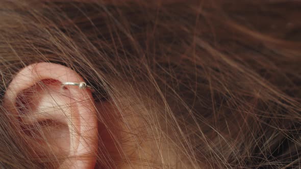 Closeup of Ear Piercings on Young Millenial or Generation z Girl