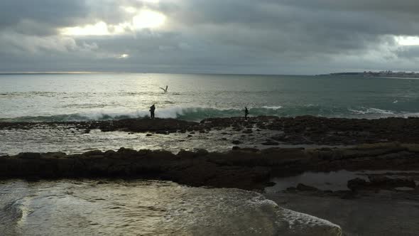 4k footage- Fisherman sunset work on Cascais coast in Portugal.