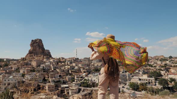 Woman Tourist Wrapped in a Shawl Looks at the Old Town in Turkey