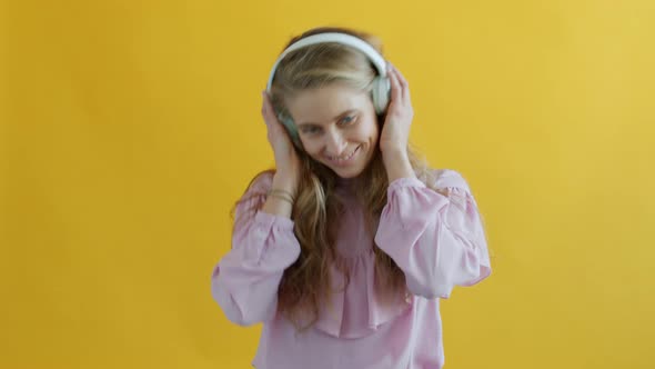 Slow Motion Portrait of Young Lady Dancing Having Fun Listening to Music Through Headphones