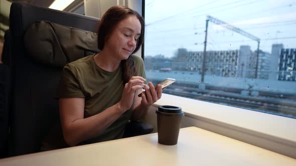 Portrait of a Middleaged Woman on a Train Using a Smartphone Chatting with Friends Hand Internet