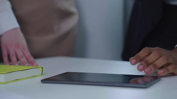 Hands of People Using Tablet at Business Meeting