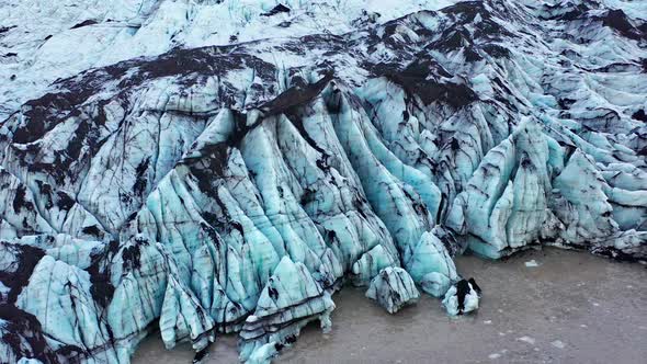 Drone Over Blue Glacier In Sunlit Mountain Landscape