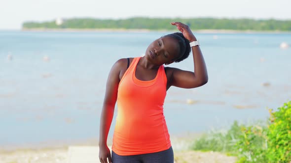 Young African American Woman Stretching Outdoors