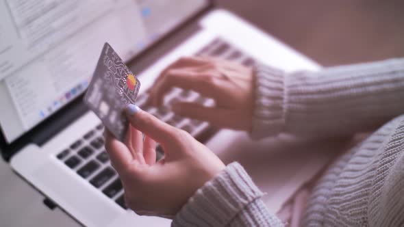 Hands Holding Credit Card and Using Laptop. Online Shopping