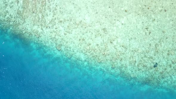 Aerial seascape of tropical island beach break by blue sea and sand background