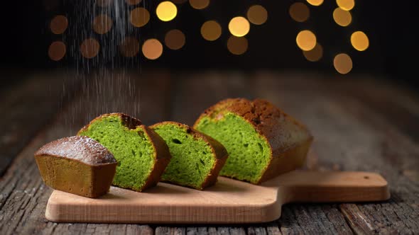 Stollen Christmas Bread Made of Spirulina and Pistachios Sprinkled with Powder for the Holidays