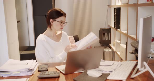 Young Business Woman in Glasses Working in Office Interior on Pc on Desk Typing