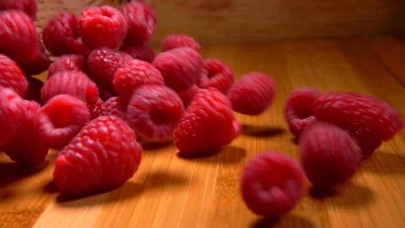 Large Juicy Raspberries Spill Out of Wicker Basket