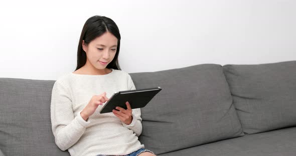 Woman use of digital tablet computer at home