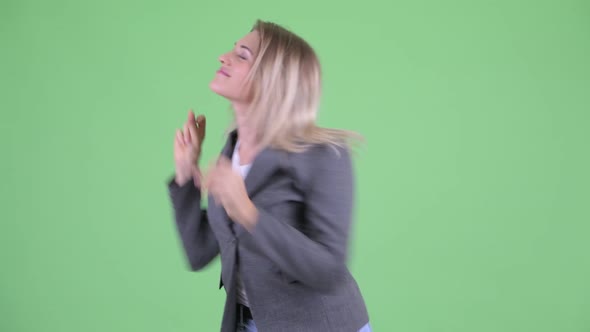 Happy Young Blonde Businesswoman Dancing