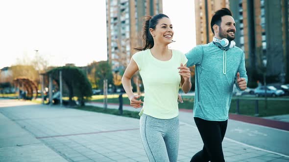 Happy Friends and Sports People Jogging and Running Outdoor