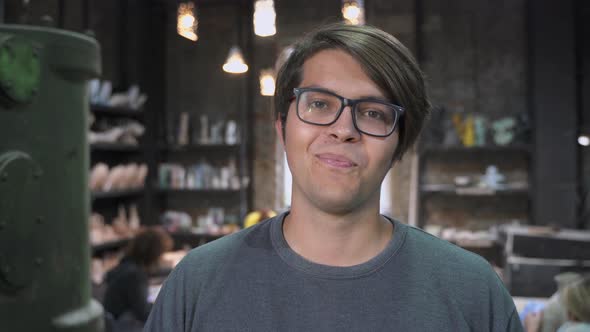 The Guy in the Pottery Workshop Poses for the Camera