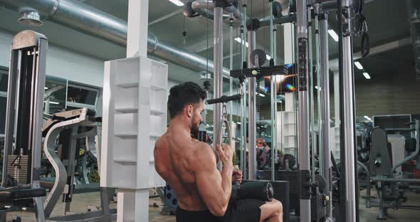 Good Looking Man Lifting Up the Weights at Gym 