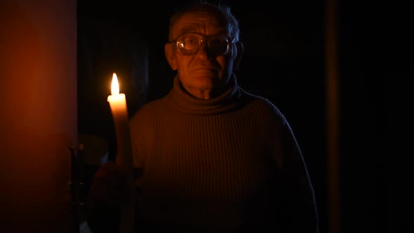 Elderly Old Man Grayhaired in Glasses Sight Holding Lit Candle Fire Hands