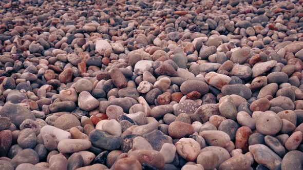 Moving Over Beach Pebbles At Sunset