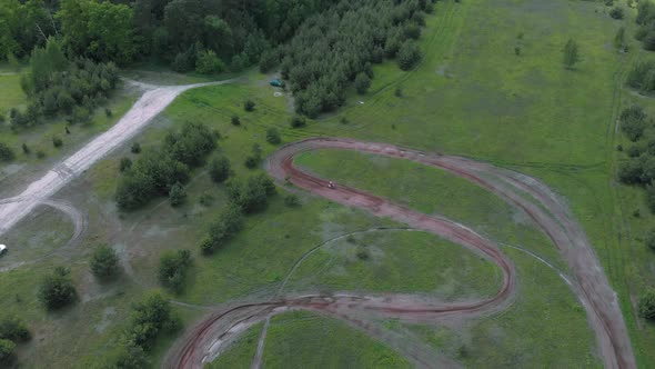 Professional motocross bike rider drives on motocross motorcycle track