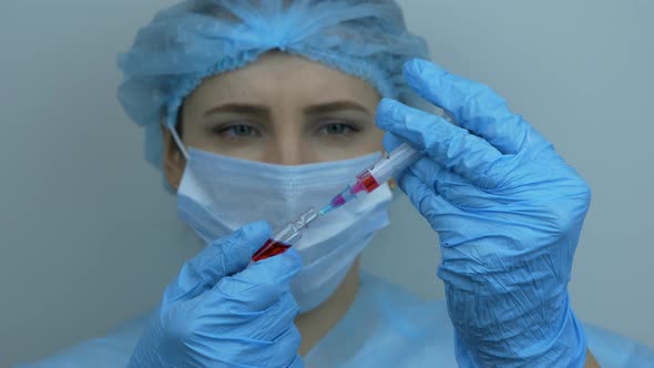 Technician carefully preparing syringe for injection. Preventive medications for coronavirus COVID 