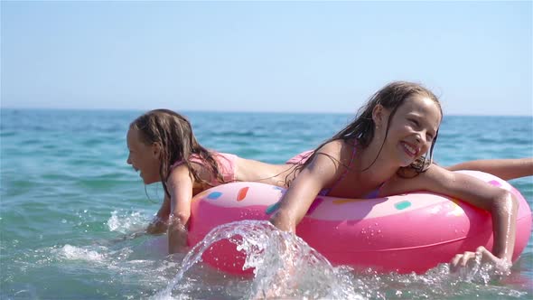 Little Girls Having Fun at Tropical Beach During Summer Vacation Playing Together