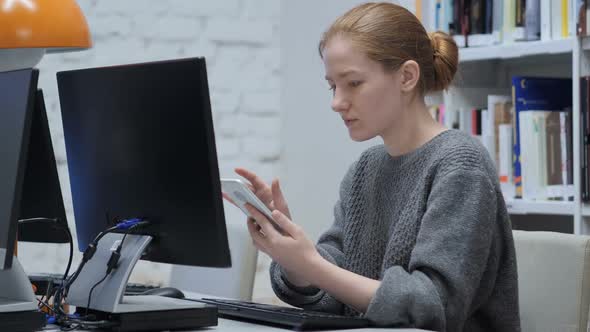 Redhead Woman Browsing Internet Online on Smartphone