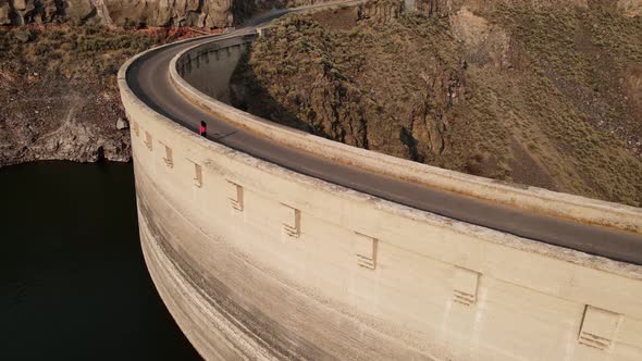 Aerial of a woman hiking across the Salmon Falls Dam in Southern Idaho