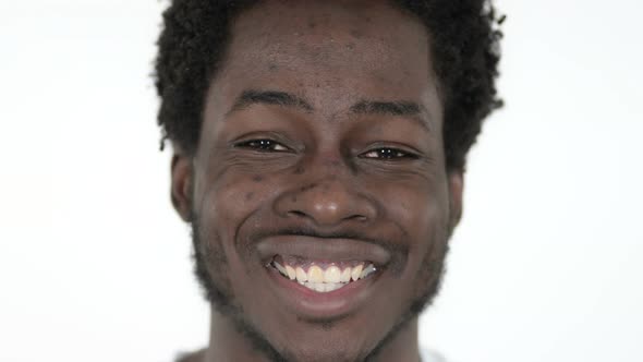 Face Close Up of Smiling African Man, White Background