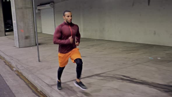 Athletic Male Running Through A Tunnel