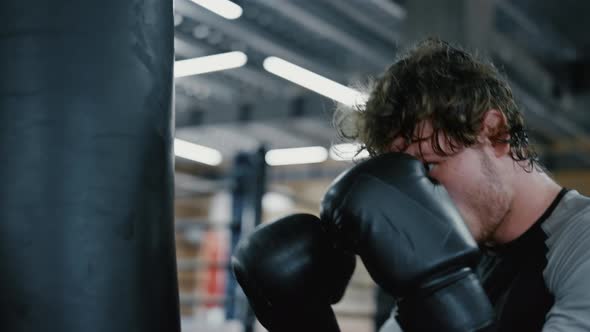 Eager Fighter Working Out in Fitness Center. Kickboxer Training Blows at Gym