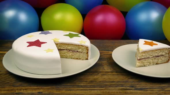 Cake With Slice On Plate At Kids Birthday Party