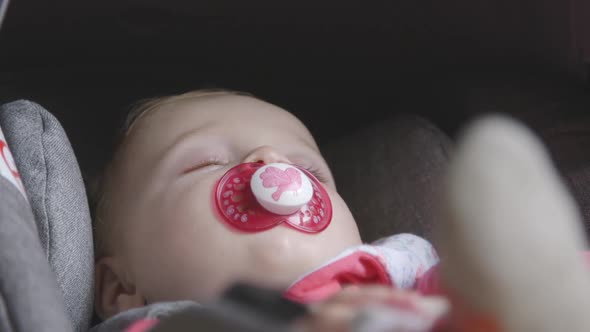 Baby boy sleeping in pram