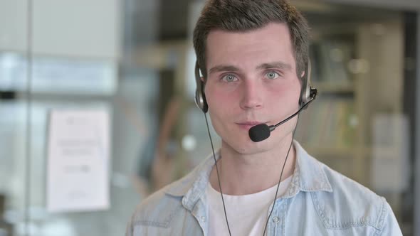 Portrait of Call Center Employee Wearing Headset and Smiling