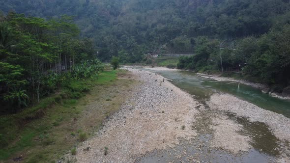 Beautiful aerial view of a less water river in the middle of the mountains in the morning