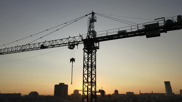 Construction Crane on a Construction Site in the City at Sunrise. Kyiv, Ukraine. Aerial View