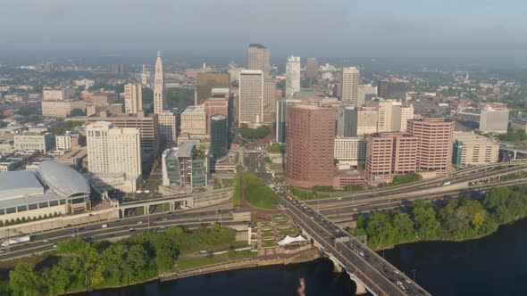 Aerial of busy street and commercial buildings along river coast Hartford