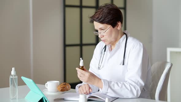 Confident Professional Doctor Talking in Video Chat Showing Medications