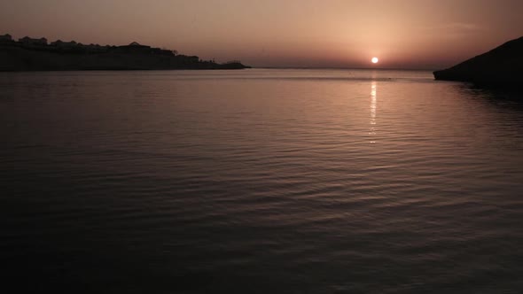 Wide shot of warm morning sunrise over Calm sea lagoon without waves, Egypt