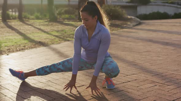 Caucasian woman stretching in a park