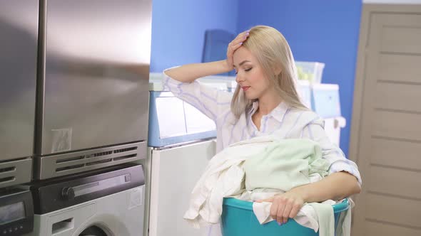 Woman in a Public Laundry Waiting for Laundry Laundry Room