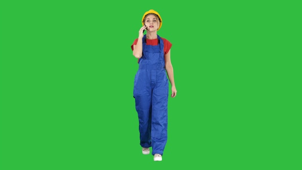 Female construction woman making a call on a Green Screen