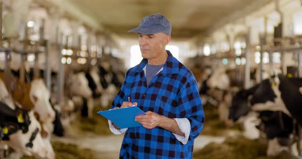 Agriculture - farmer using digital tablet at stable