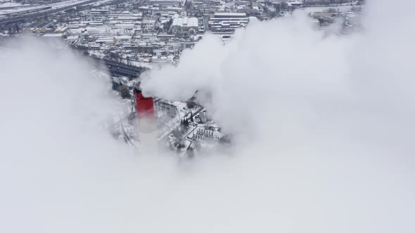 Winter View of a Big Modern Industrial City with Two Tall and Heavily Smoking Factory Pipes