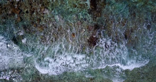 Wide flying travel shot of a summer white paradise sand beach and blue ocean background in hi res 4K