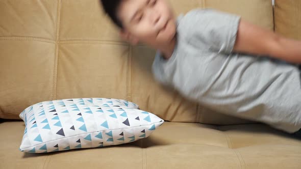 Boy Falls Face Down on Sofa Slow Motion