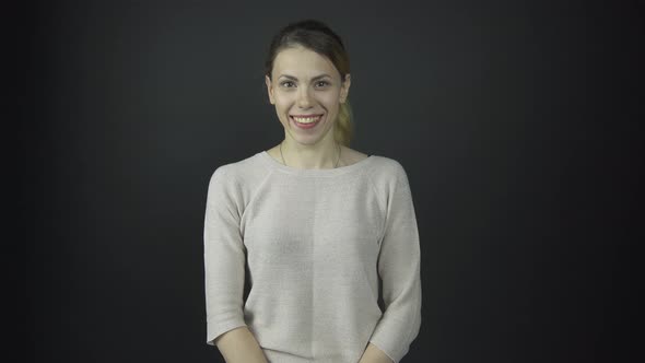 Lady with Long Hair in Ponytail Smiles and Looks Around