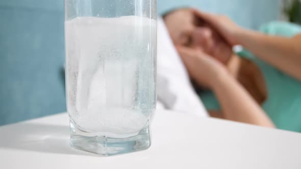Slow Motion Video of Woman Lying in Bed Suffering From Migraine Looking on Glass of Water with
