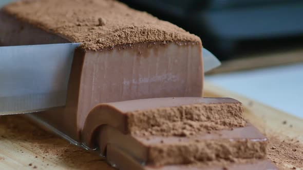 Close Up Of The Knife Is Cutting Chocolate Pudding