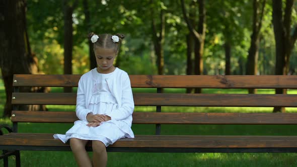 Sad Girl Lonely Sitting on Bench Waiting for Future Parents Coming, Orphan